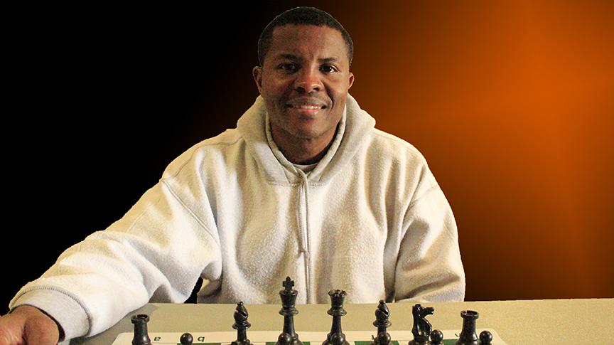 CURTIS WILLIAMS SHOWING HE IS A REAL CHESS PLAYER - PHOTO AND GRAPHICS BY JIM HOLLINGSWORTH
